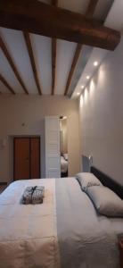 a large white bed in a room with wooden ceilings at Casa Stella in Genzano di Roma
