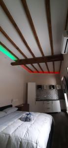 a bedroom with a white bed with red and green lights at Casa Stella in Genzano di Roma