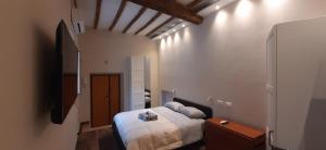 a bedroom with a bed in a small room at Casa Stella in Genzano di Roma