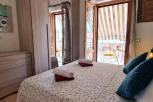 a bedroom with a bed with two towels on it at Little Home in Bolsena