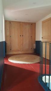 a room with wooden cabinets and a large rug at Mas de la Sorgue - Rendez-vous en Provence in Bédarrides