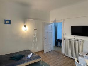 a living room with a table and a flat screen tv at Apartamenty i pokoje przy sopockim molo in Sopot