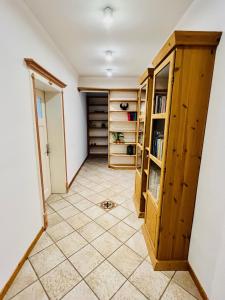 a hallway with wooden cabinets and a tiled floor at Ferienwohnungen Maedchen in Wunstorf