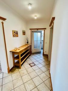 a room with a table and a tiled floor at Ferienwohnungen Maedchen in Wunstorf