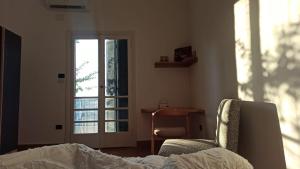 a bedroom with a bed and a chair and a window at Dokki I Madina Apt I 2min to Nile in Cairo