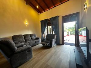 a living room with a couch and a chair at Sagya Residencies in Panadura