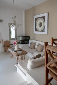 a living room with a couch and a table at Anemoi Resort in Naousa