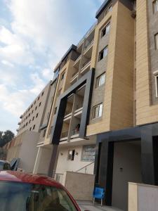 a building with a red car parked in front of it at صن سيتي in Cairo