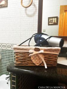 a wicker basket with a blow dryer on a counter at Casa rural compartida Casa de la Mancha in Mota del Cuervo