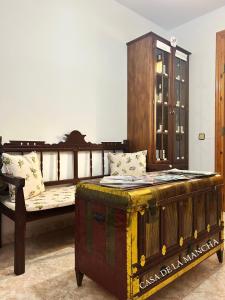 a bedroom with a wooden bed and a wooden trunk at Casa de la Mancha in Mota del Cuervo