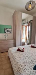 a bedroom with a bed with a mirror on it at Little Home in Bolsena