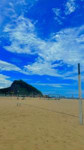 a view of a beach with a hill in the background at house JV in Rio de Janeiro