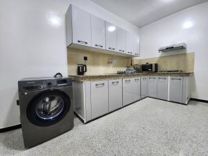 a kitchen with a washing machine in a room at Residence Al Kasbah - VacayX - Chic Triplex 3BR -RABAT in Rabat