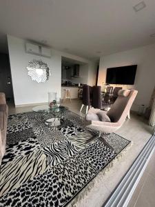 a living room with a zebra patterned rug at Cozy Oasis with Panoramic Views in Cerritos