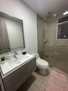 a bathroom with a sink and a toilet and a shower at Cozy Oasis with Panoramic Views in Cerritos