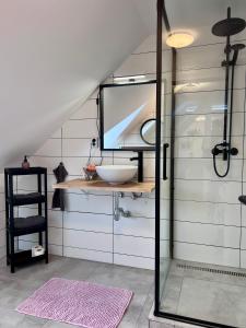 a bathroom with a sink and a mirror at Apartmán U Bobovky - Lipno nad Vltavou in Lipno nad Vltavou