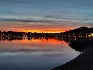 a sunset over a large body of water at Apartments & Room Paula in Split