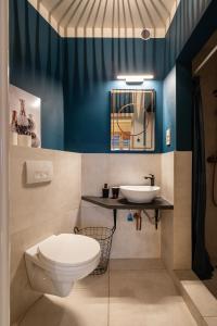 a bathroom with a toilet and a sink at Park&Art Boutique Suites in Budapest