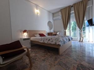 ein Schlafzimmer mit einem Bett, einem Stuhl und einem Fenster in der Unterkunft Il Merlo in Pisa