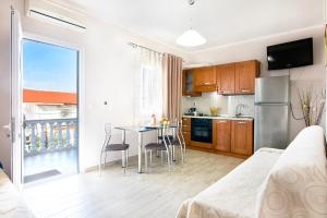 a kitchen and dining room with a table with chairs at Maria Rooms in Polychrono