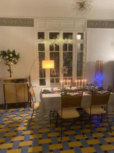 a dining room with a table with candles on it at VILLA MARYSE avec piscine privative in Saint-Laurent-de-la-Salanque