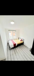 a bedroom with a bed in a room with a window at Double ensuite room in Leicester