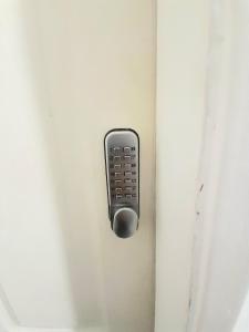 a remote control sticking out of a door at Double ensuite room in Leicester