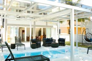a patio with chairs and a swimming pool at OPY CAMBOA in Governador Celso Ramos