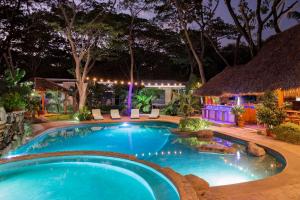 a swimming pool in a resort at night at Casa Papaya - Eco Casita Phase 1-1 in Iguana