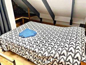 a black and white bed with a blue pillow on it at L5 Duplex studio with balcony! 2`from the metro in Barcelona