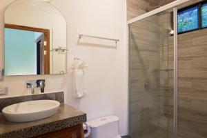 a bathroom with a sink and a shower at Casa Papaya - Eco Casita Phase 1-1 in Iguana