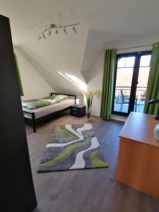 a living room with a large rug on the floor at Ferienwohnung "Sanssouci", Mülheim Selbeck in Mülheim an der Ruhr +17 photos