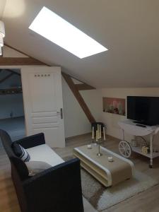 a living room with a skylight in a attic at Gîte Les Longères in Montazeau