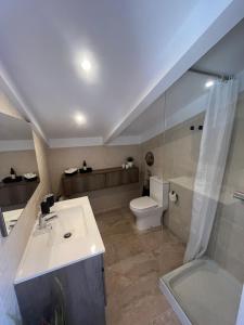 a bathroom with a sink and a toilet at Apartament Villa Luisa in Can Trabal +11 photos