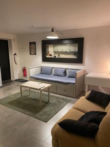 a living room with a couch and a table at Ny lägenhet på markplan med havsutsikt in Strömstad