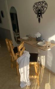 a dining room table with two chairs and a mirror at Apartamento con garaje, sin escaleras y muy bien ubicado in Palmira