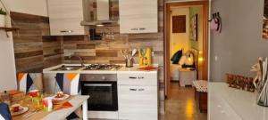 a kitchen with a sink and a stove top oven at Little Home in Bolsena