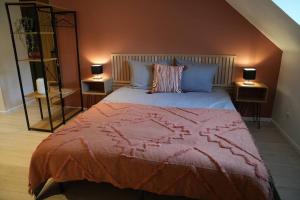 a bedroom with a large bed with two night stands at Cocon du Florival in Guebwiller