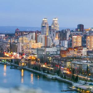 a city at night with a river and buildings at Европейская 17 Мост сити Центр in Dnipro