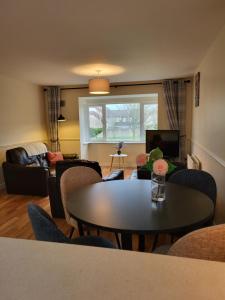 a living room with a table and chairs at Greenview in Ballysheedy