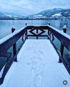 a bridge over a body of water with snow on it at Art of Harmony in Piatra Neamţ
