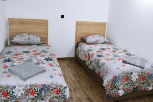 two twin beds in a room with at Big Central Apartment in Skopje