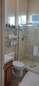 a bathroom with a shower and a toilet and a sink at Roseville Properties in Roseville