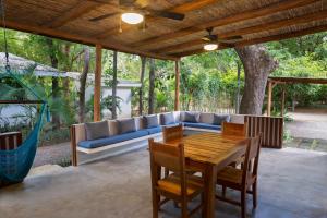 a patio with a blue couch and a table and chairs at Eco Casita 11 in Rivas