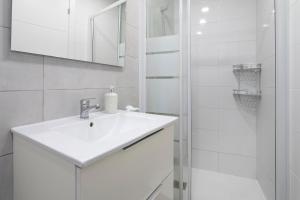 a white bathroom with a sink and a shower at El rincon de Mauro in Altea +13 photos