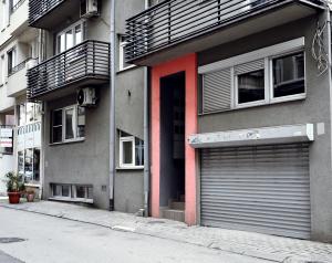 a building with two garage doors on a street at Big Central Apartment in Skopje