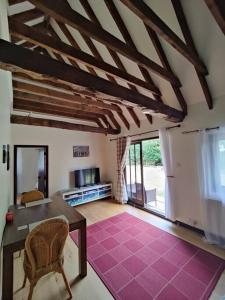 a living room with a table and chairs in a room at Parsonage Barn Annex in Winchelsea