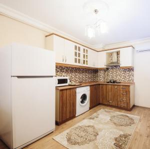 a kitchen with a refrigerator and a washer and dryer at Overland Residence in Istanbul