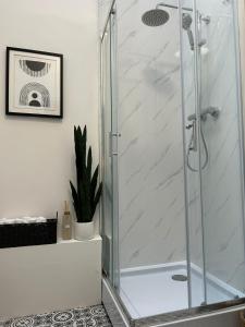 a shower with a glass door in a bathroom at Whitchurch High Street Hideaway in Whitchurch