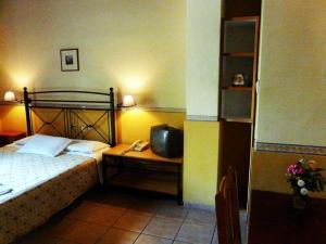 A bed or beds in a room at Alexandros Studios & Apartments